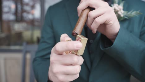 man in green suit lighting a cuban cigar in 4k slow motion