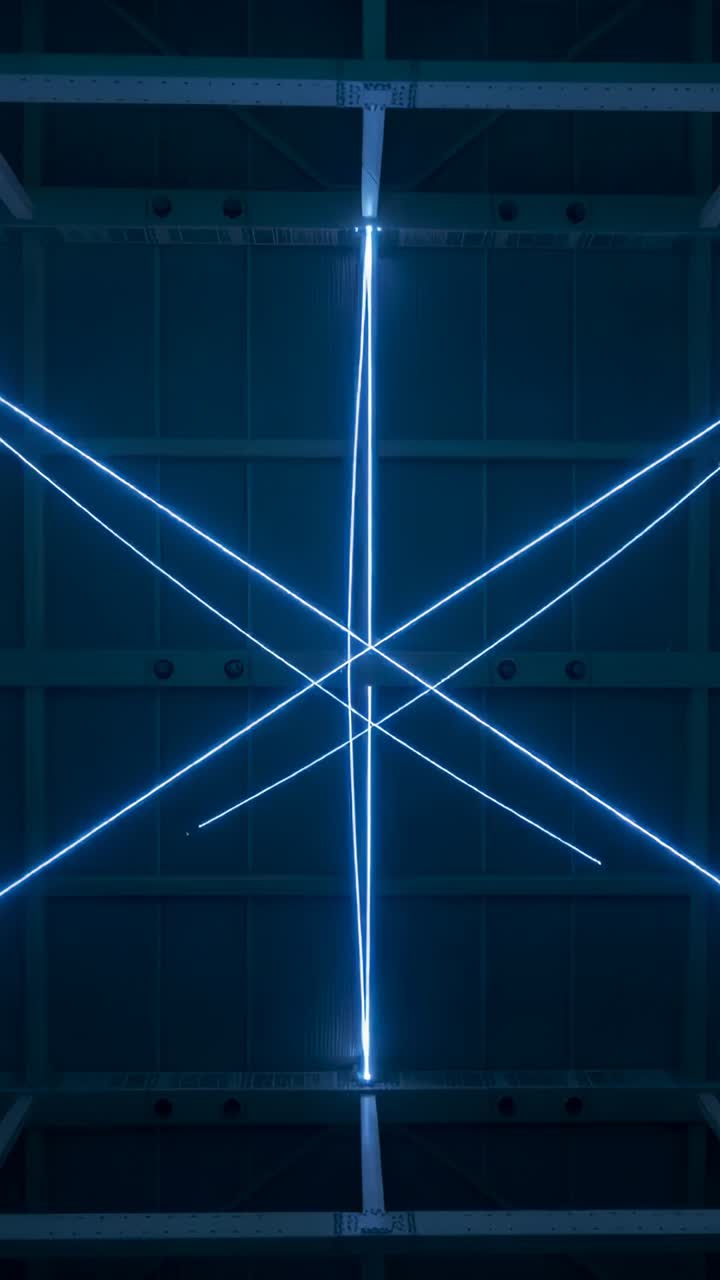 Vertical video: Starting lights in gallery, ceiling rig shifting blue lines forming grid over beams