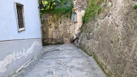 narrow alleyway with stone walls and pavement