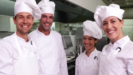 Team-of-chefs-putting-hands-together-and-cheering