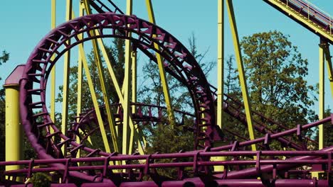 visitors to amusement park ride a roller coaster. dead loop attraction