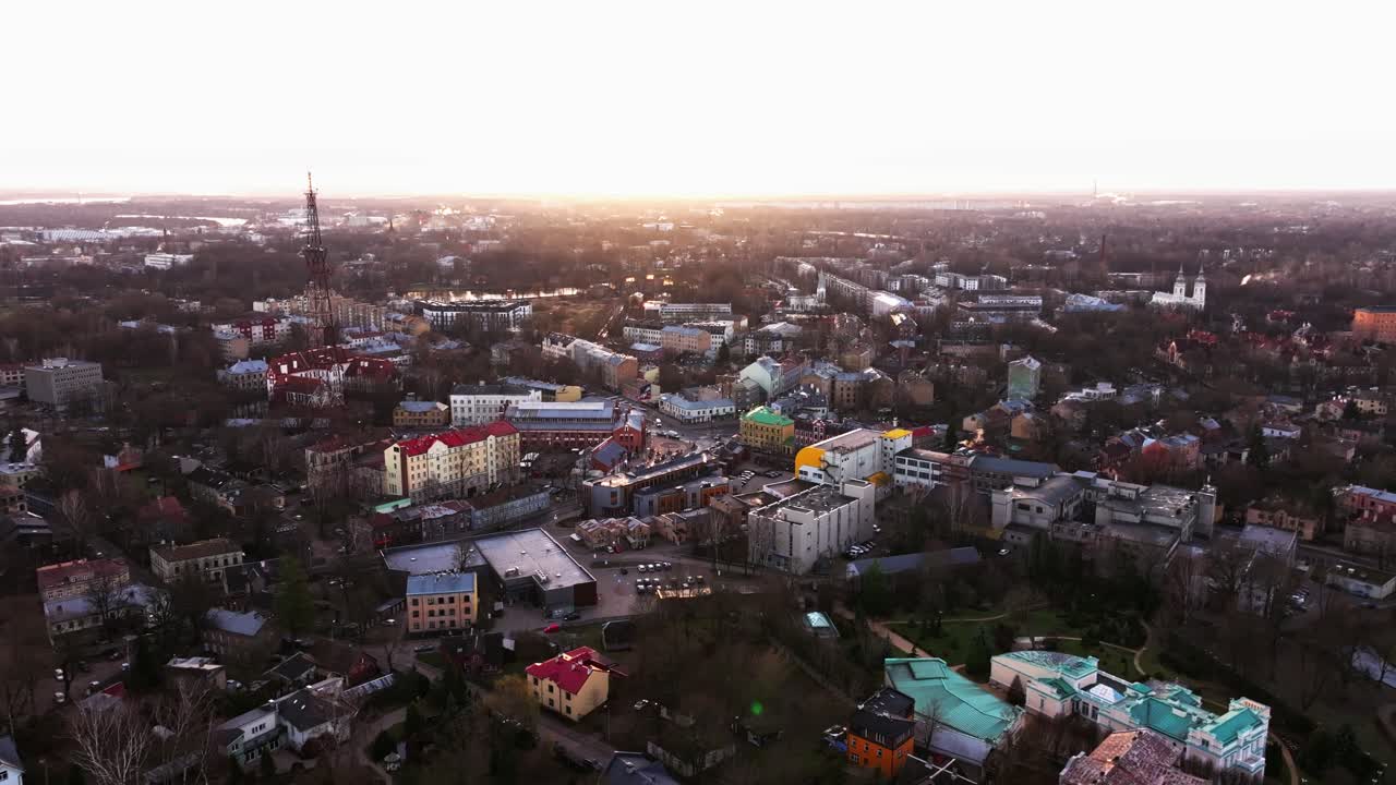 Golden hour drone shot over Āgenskalns market area, Riga with warm city lighting