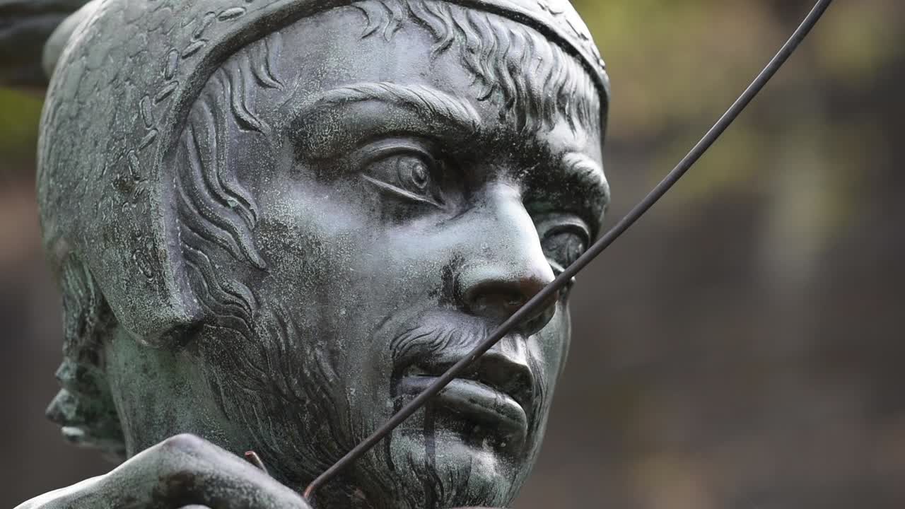 The Robin Hood statue stands proudly on Castle Road in Nottingham, England, aiming his arrow toward the historic gatehouse of Nottingham Castle