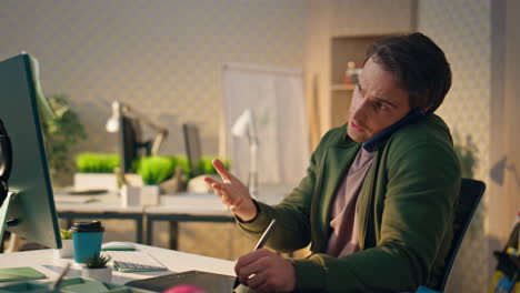 talking freelancer explaining phone call at monitor closeup. man drawing tablet