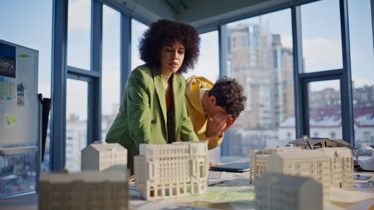 Architectural specialists looking laptop reading bad news in agency office
