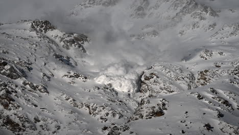 avalanche fog descends a snowy rocky mountain in the swiss alps, zermatt