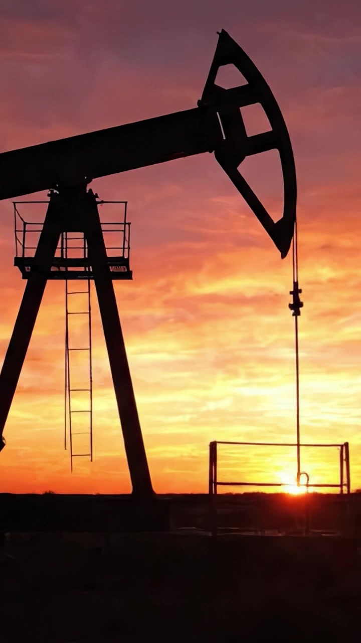 Silhouettes of Oil Pumps Against a Vivid Sunset: Capturing the Industrial Landscape of Energy Production in the Twilight Hours