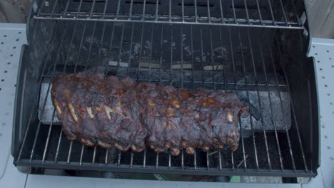 high angle shot of delicious spareribs being grilled on barbecue