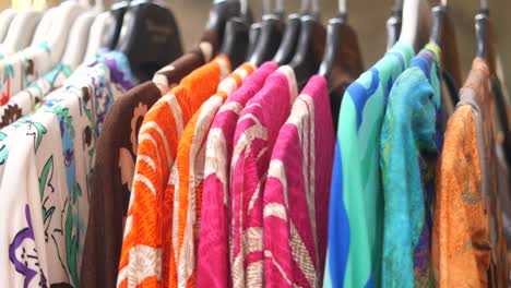 colorful clothes on hangers in a boutique