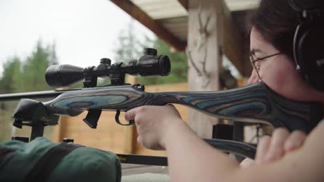 adjusting telescopic rifle sight and easing trigger to fire off shot