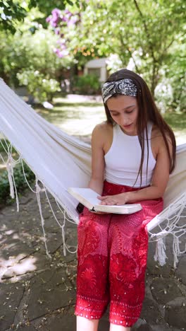 woman reading in a hammock in a garden