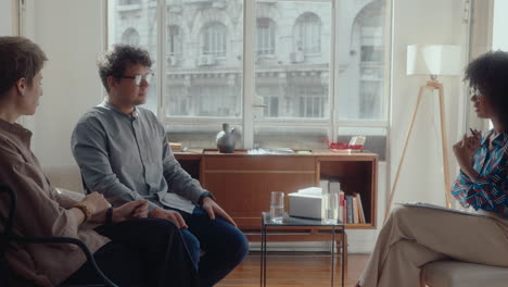 family couple coming to agreement with help of therapist