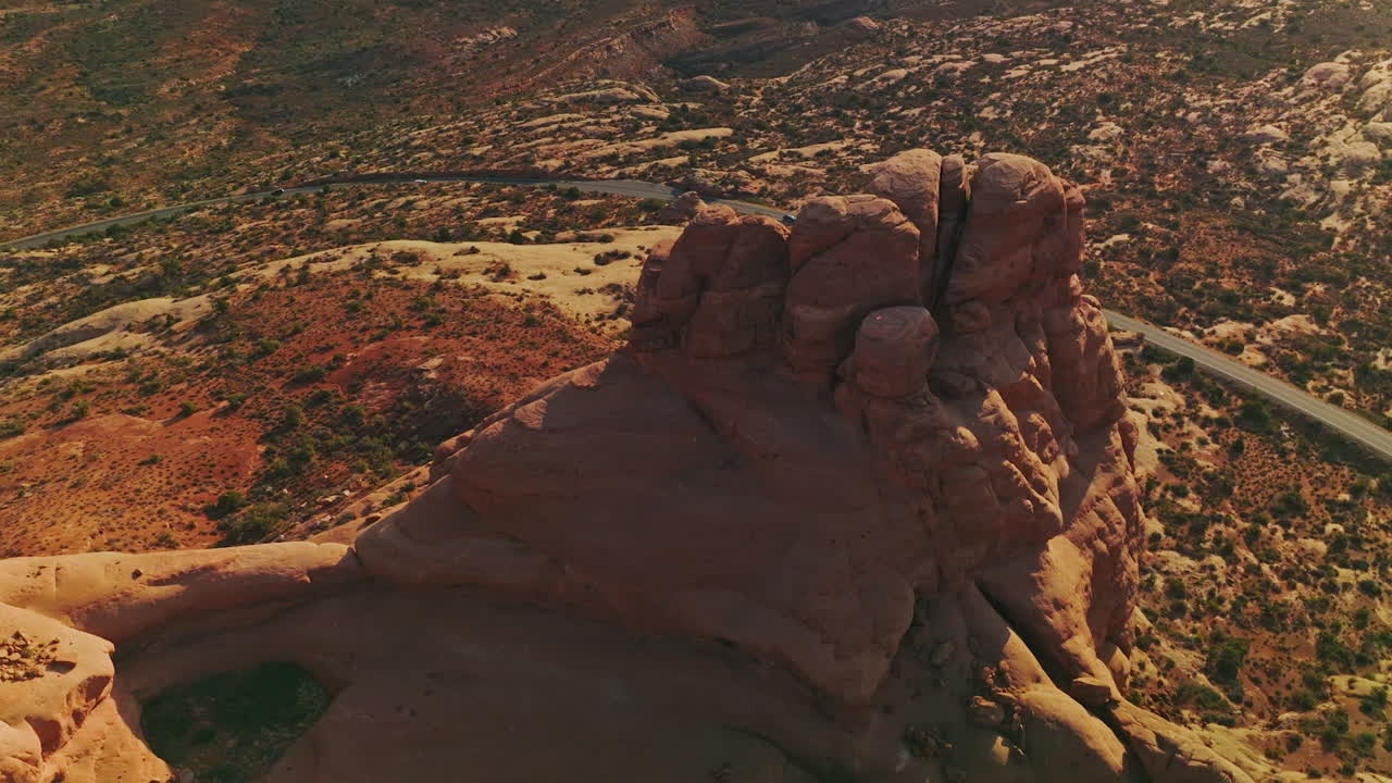 Odd rounded tops of the rock in the beautiful national park of America. Car going by the speed highway round the mount. Top view.