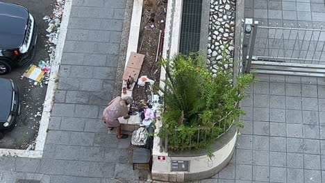 Homeless-drunkard-old-man-on-the-street-sits-and-drink