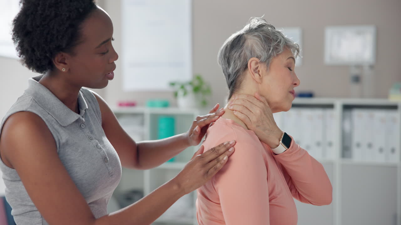 Physical Therapist Helping Senior Woman with Neck Pain