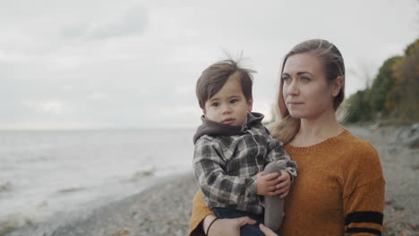 A-young-mother-walks-with-her-son-on-the-shores-of-the-picturesque-Lake-Ontario