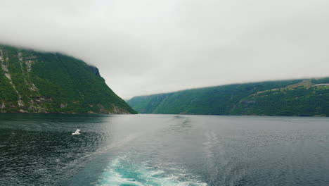 view from the stern of the ship to the picturesque norwegian fjord the majestic nature of norway a c