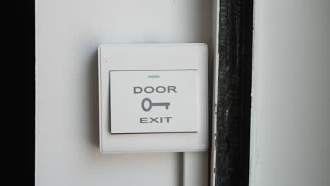 man clicking a button to open door