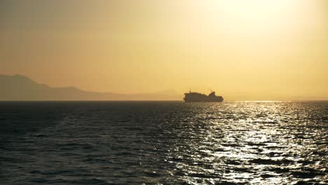 sunset and a ferry sailing on the greek waters of the ionian sea