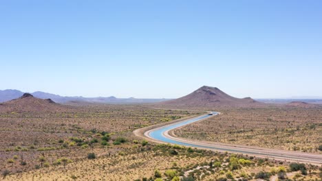 Aerial-pull-back-to-reveal-the-extent-of-the-Central-Arizona-Project-running-through-the-Salt-River-Pima-Indian-Reservation,-Scottsdale,-Arizona