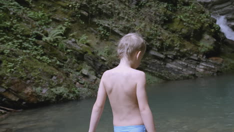 child enjoying a waterfall