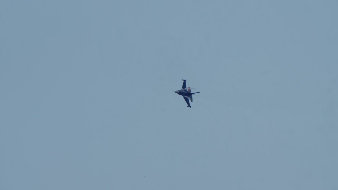 Fighter Jet Flying and Maneuvering in a Clear Blue Sky