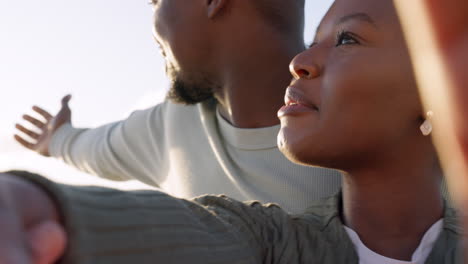 African-couple-taking-selfie-at-the-beach