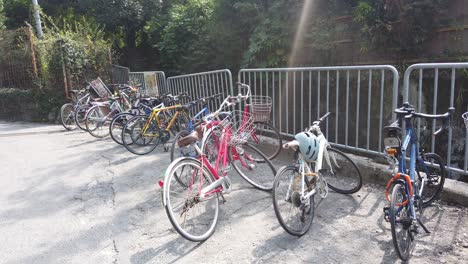 colorful bicycles parking lot next to a mountain forest in kyoto japan in summer