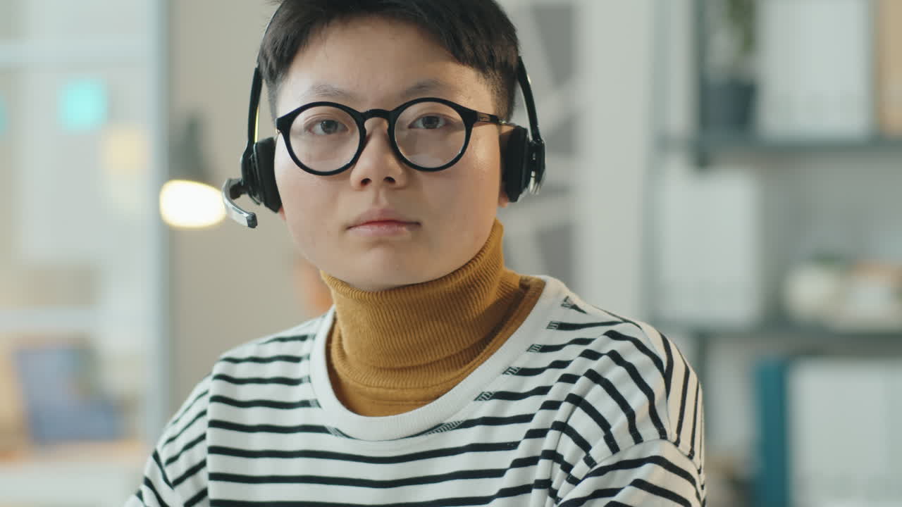 Portrait of Asian Woman at Work in Call Center
