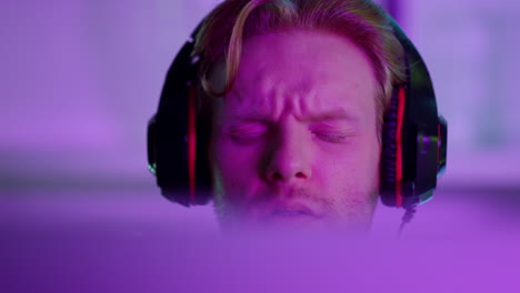 upset man losing computer game closeup. angry gamer shouting looking screen
