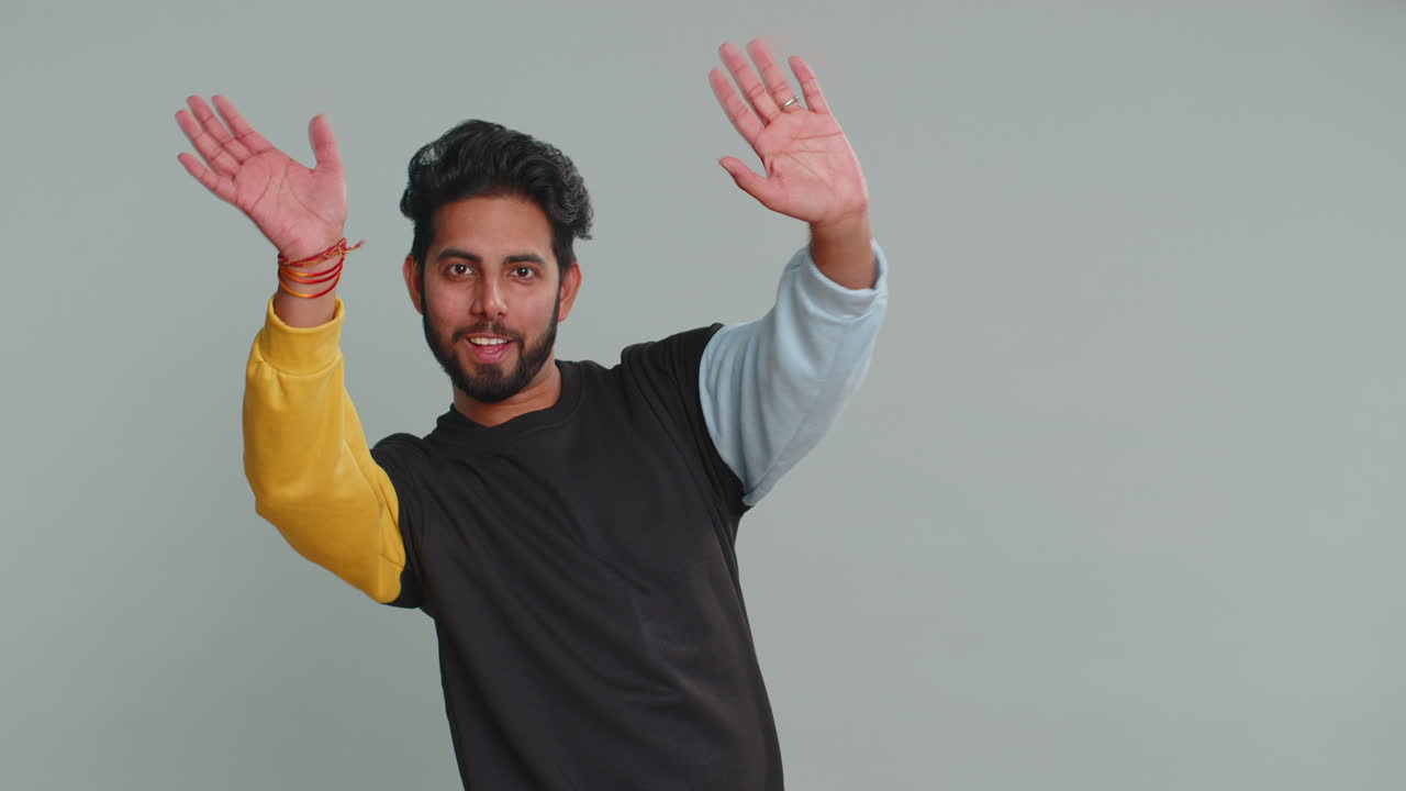 Man showing inviting gesture with hands ask to join beckoning to coming gesturing hello greetings