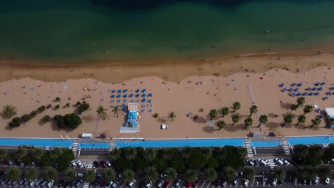 Amazing-Sandy-Beach-With-Blue-Lagune-Sea-Seaside-Seashore-Coastline-in-Spain-Tenerife-Drone-Shot-in-4K