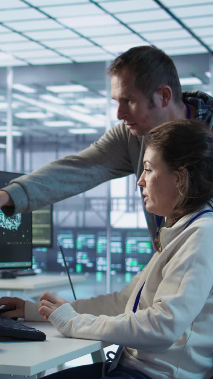 IT Professionals Collaborating on Computer in Modern Data Center