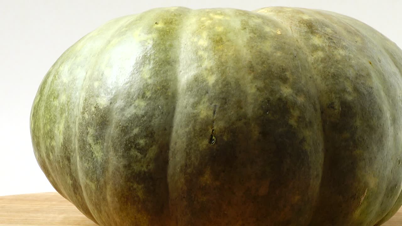 Pumpkin on a kitchen board. Shooting in the movement