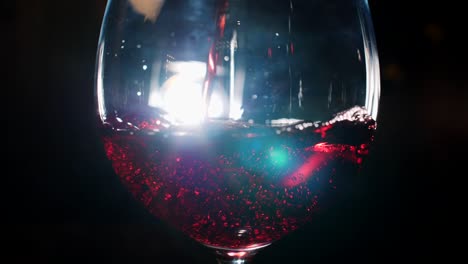 pouring red wine into a glass