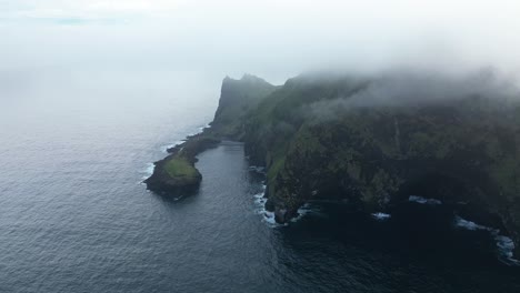 aerial view of misty scenery in south of iceland, dense fog over elephant rock famous landmark