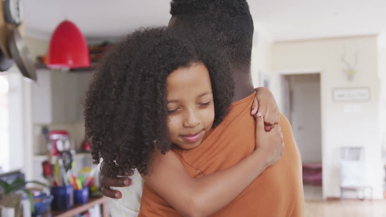 African american father and daughter hugging