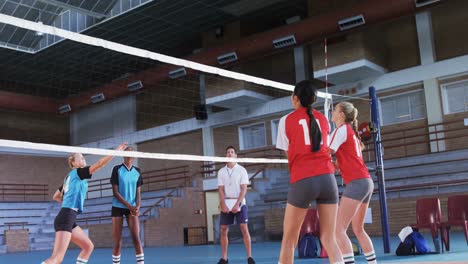 female players playing volleyball in the court 4k