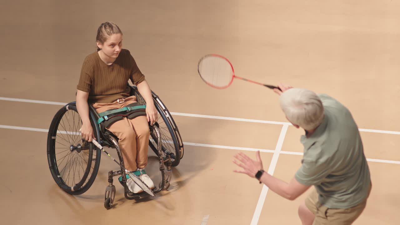 Girl with Disability Learning Badminton from Coach