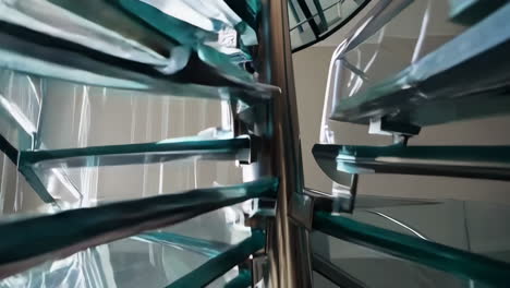 modern glass spiral staircase in a luxury home