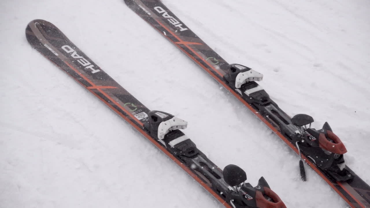 Slow motion: skis are launched on snowy ground in the Swiss Alps