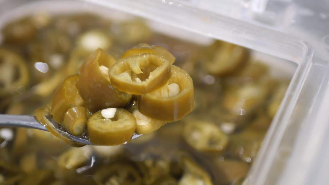 Jalapeno peppers on spoon close up ,