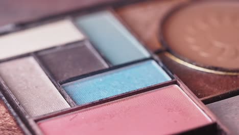 close-up of makeup palette and brush