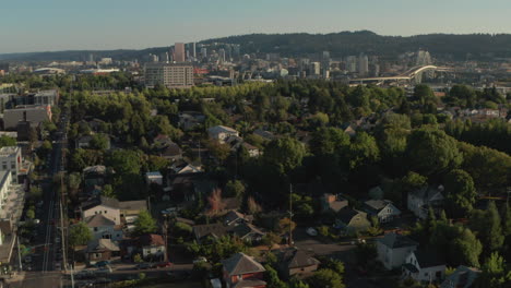 aerial slider shot over green neighbourhood looking towards downtown portland