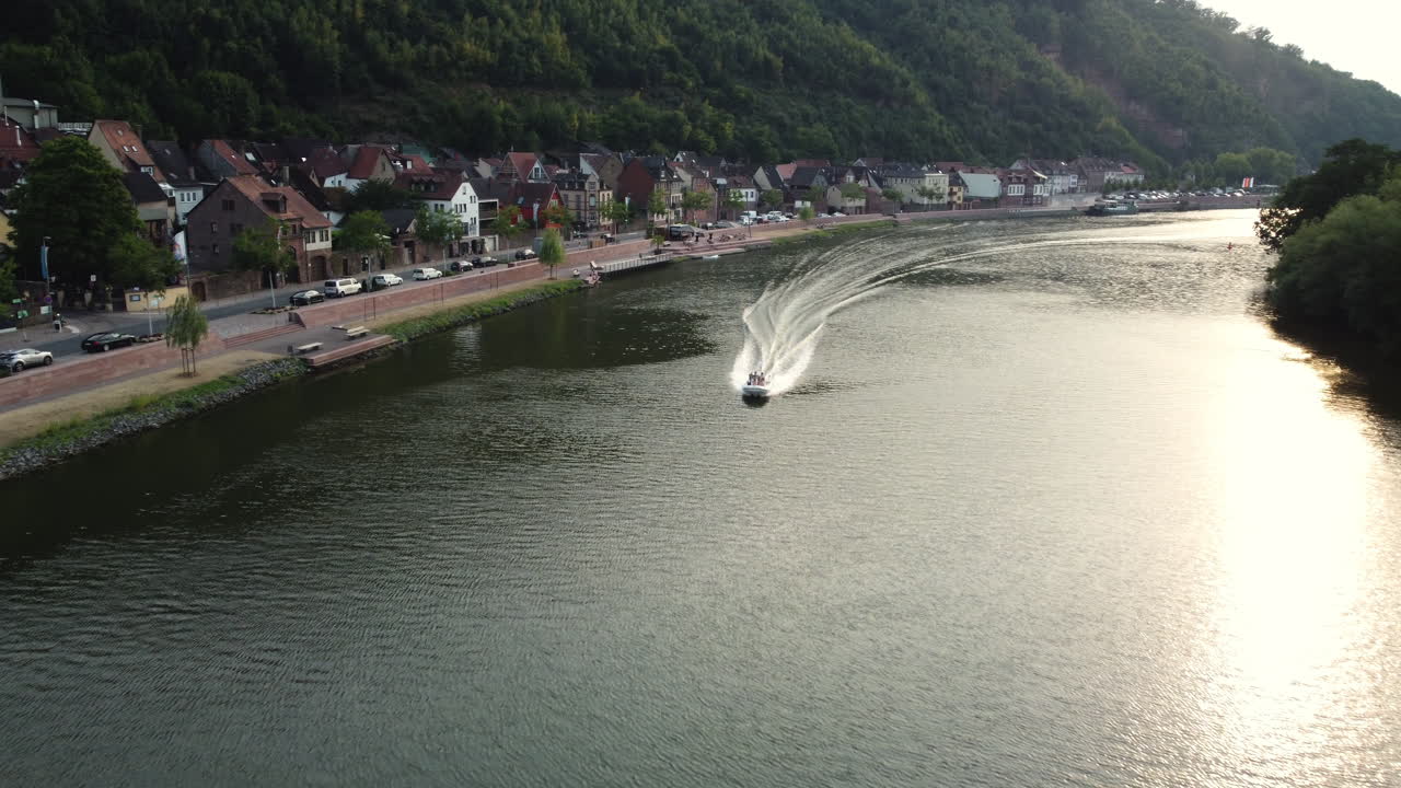 Aerial view of a motorboat on the Rhine River near a charming town