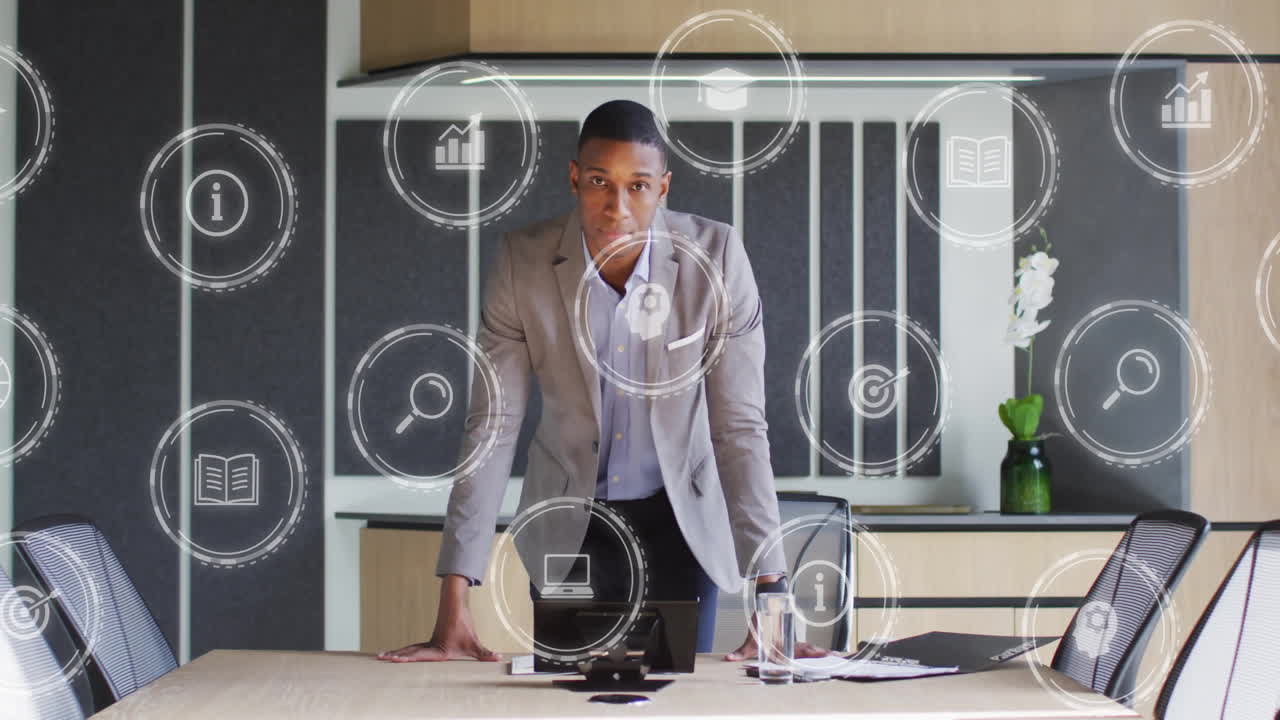 Animation of digital icons over african american businessman in office