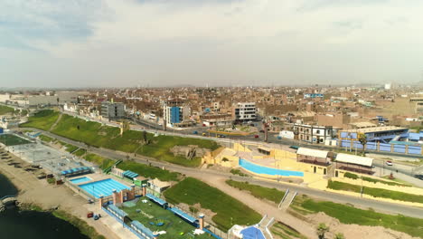 aerial view around pools and a skate park on the coast of sunny huacho, peru
