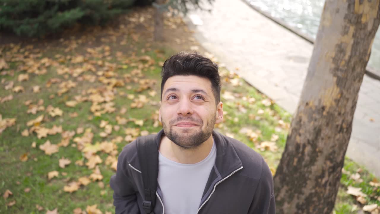 retrato al aire libre de un joven mirando al cielo.