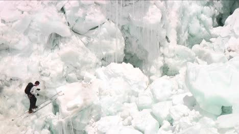 Climber-crossing-ladder-in-icefall