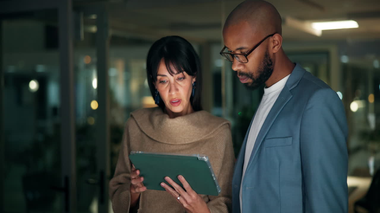 Business professionals collaborating with a tablet in the office